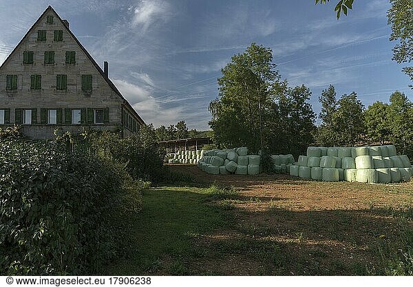 Franconian farmhouse with stored silo bales on the farm  Upper Franconia  Bavaria  Germany  Europe