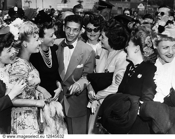 FRANK SINATRA (1915-1998). American singer and actor. Surrounded by female fans in Pasadena  California  11 August 1943.
