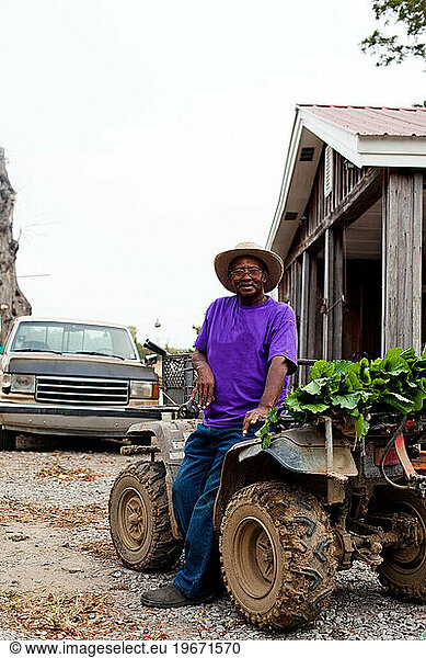 Frank Wilbourn  a local farmer  at his home in rural Mississippi harvesting zucchini and squash.