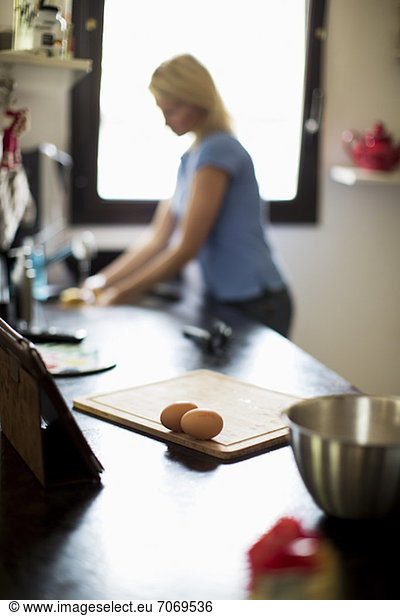 Frau bei der Zubereitung von Speisen in der Küche