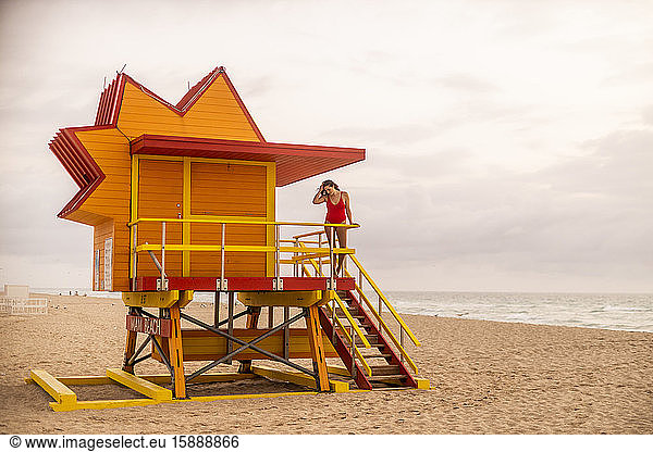 Frau im roten Badeanzug auf Rettungsschwimmerhütte in Miami Beach  Miami  Florida  USA