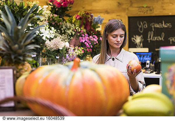 Frau kauft Obst im Lebensmittelgeschäft