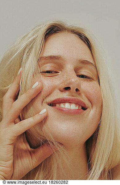 Freckles blonde blue-eyed woman  perfect skin  smiling