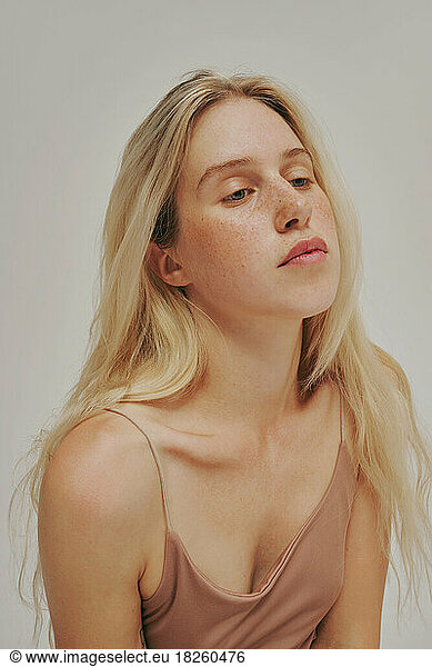 Freckles blonde Woman portrait. Close-up  blue eyed girl  perfect skin