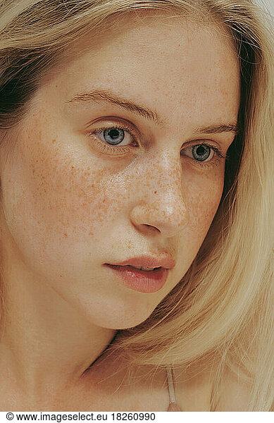 Freckles blonde Woman portrait. Close-up  blue eyed girl  perfect skin