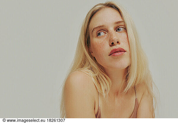 Freckles blonde Woman portrait. Close-up  blue eyed girl  perfect skin