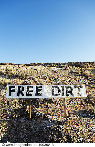 Free Dirt sign on hillside.