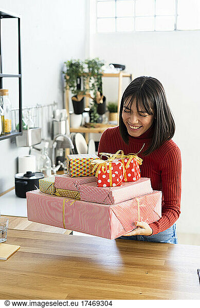 Freelancer keeping gift boxes on desk at home