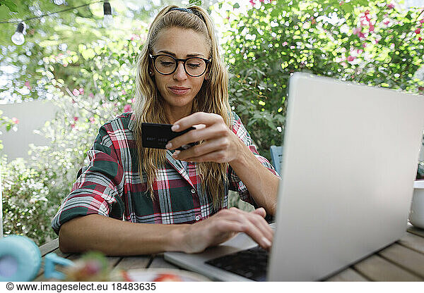 Freelancer paying with credit card on laptop