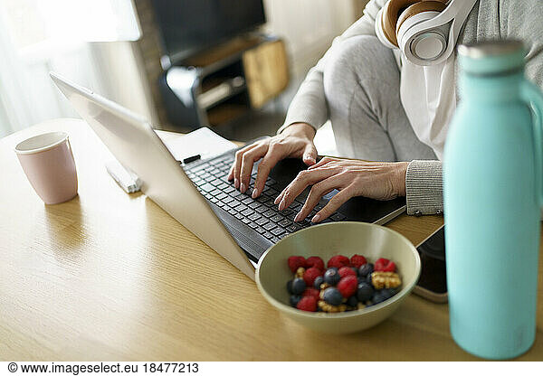Freelancer typing on laptop at desk