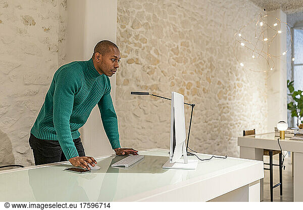 Freelancer using computer on desk at home