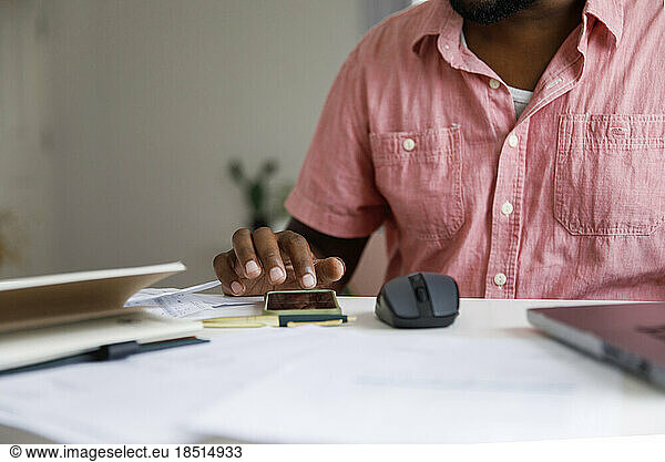 Freelancer using smart phone at home