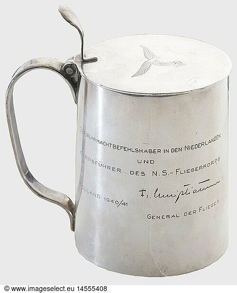 Fregattenkapitän Carl Christiansen (1884 - 1969)  a silver gift tankard from his brother Friedrich Christiansen Tapers slightly toward the top with an engraving on the right side  'Der Wehrmachtsbefehlhaber in den Niederlanden und Korpsführer des N.S. Fliegerkorps Holland 1940/41 - Fr. Christiansen Gerneral der Flieger.'(The Wehrmacht Commander in the Netherlands and Corps Commander of the N.S. Flying Corps Holland 1940/41 - Fr. Christiansen General der Flieger). On the left side there is a finely engraved view of a village with the lighthouse on the beach at the Hoek van Holland. Lid has an engraved Luftwaffe eagle and extended thumb lever. Hallmark '925' and maker's inscription  'Beveer v. Kempenavos'. Height ca. 14.5 cm. Weight 663 g.  historic  historical  1930s  20th century  navy  naval forces  military  militaria  branch of service  branches of service  armed forces  armed service  object  objects  stills  clipping  clippings  cut out  cut-out  cut-outs  vessel  vessels