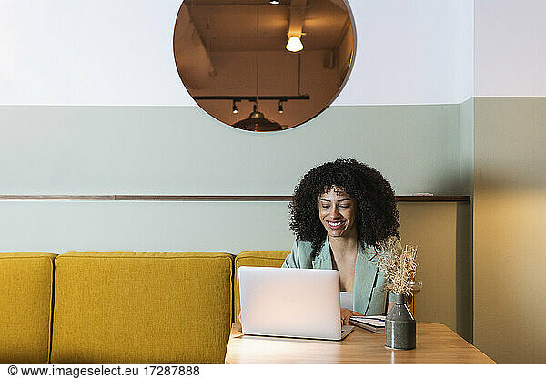 Freiberufliche Mitarbeiterin mit Laptop im Restaurant
