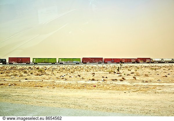 Freight locomotive moving through arid landscape  California  USA