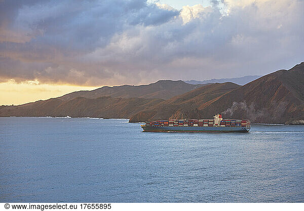 Freight ship headed out to sea from the San Francisco Bay at sunset