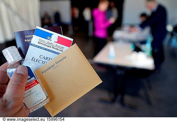 French election during coronavirus (COVID-19) crisis. Polling station. Antibacterial hand gel.