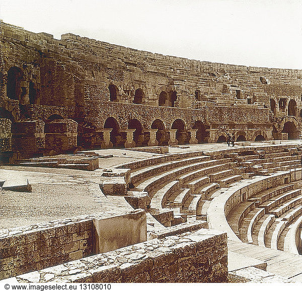 French stereoscopic editions  positives on glass from circa 1900 for viewing thought a stereoscope.view of interior des arenes. The Arena of Nîmes is a Roman amphitheatre  situated in the French city of Nîmes. Built around AD 70  it was remodelled in 1863 to serve as a bullring.