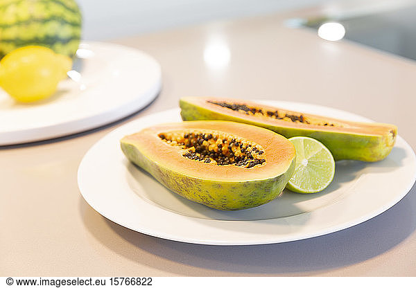 Fresh cut papaya with lime on plate