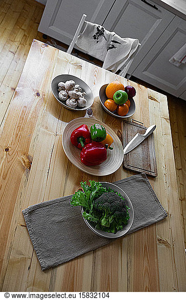 Fresh farmers tomatoes and basil on wood table.