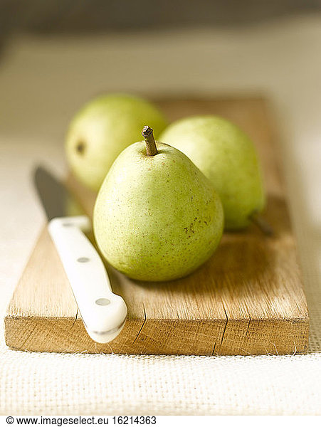 Fresh green Pears on chopping board