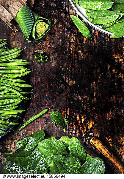 fresh organic green vegetables with copy space on wood