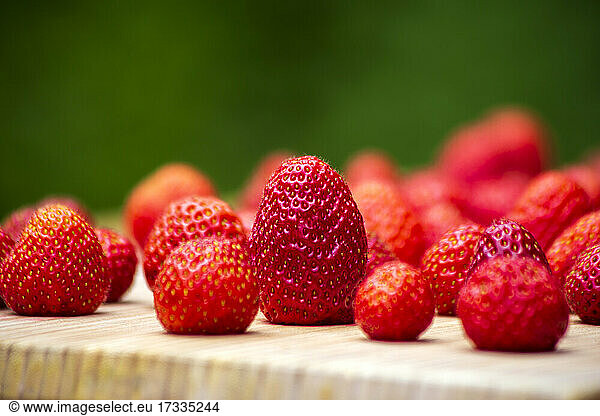 Fresh ripe strawberries on wooden cutting board