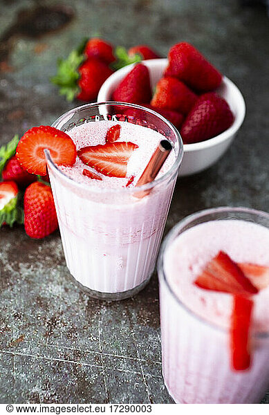 Fresh strawberries and two glasses of strawberry smoothie