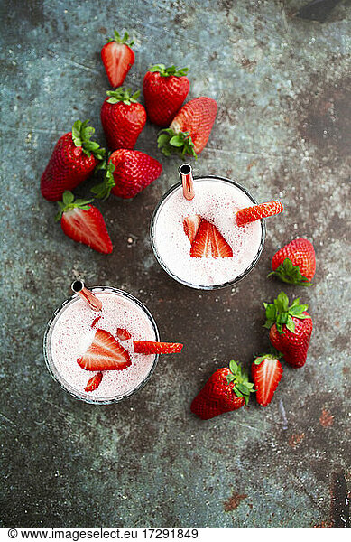 Fresh strawberries and two glasses of strawberry smoothie