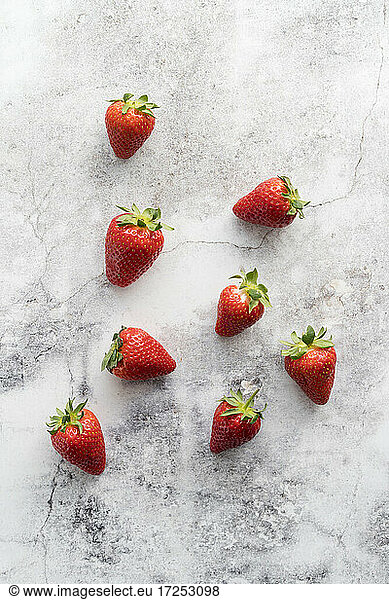 Fresh strawberries lying on white marble
