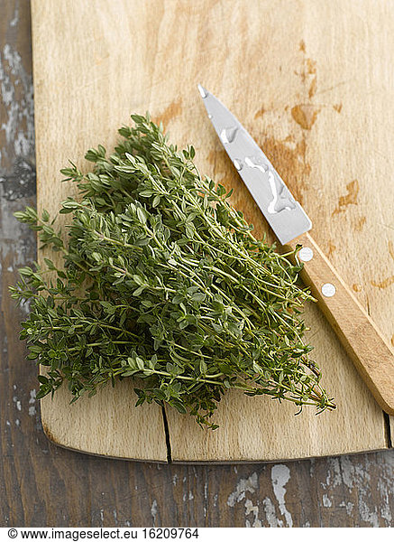 Fresh thyme on chopping board  elevated view