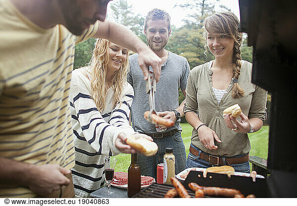Friends barbecue hotdogs and burgers near Kezar Lake  Maine