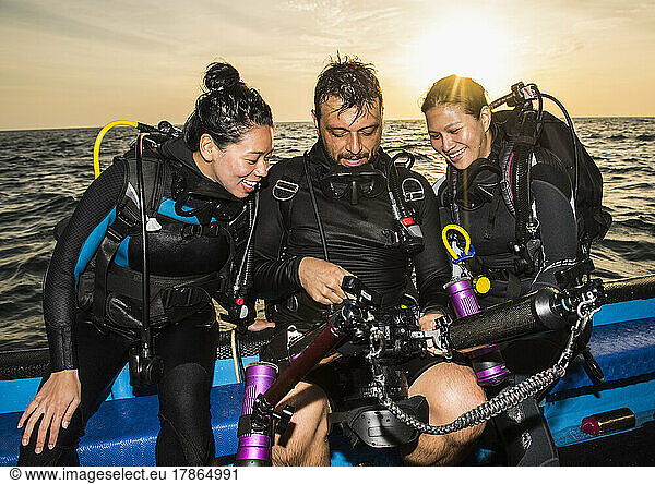 friends checking pictures on underwater camera at Tubbataha reef