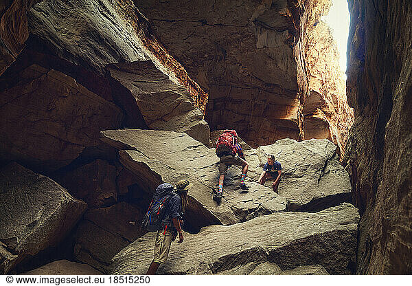 Friends climbing on rocks at Cederberg Mountain trek