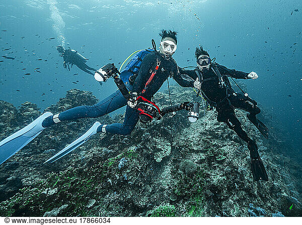 friends diving in the tropical waters at the Andaman Sea in Thailand