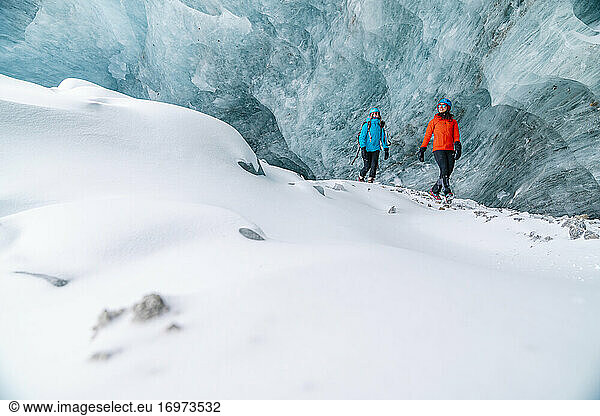 Friends Exploring Frozen Ice Caves In Alberta