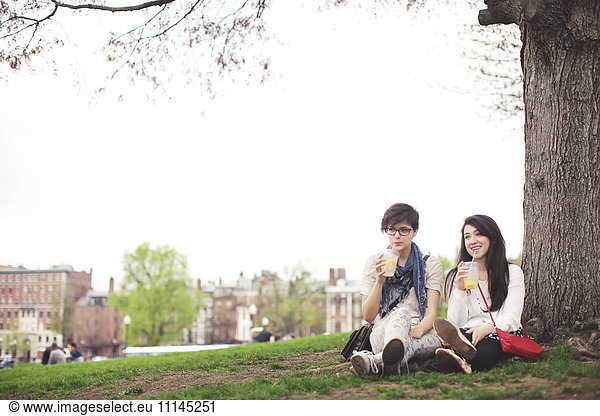 Friends having drink in urban park