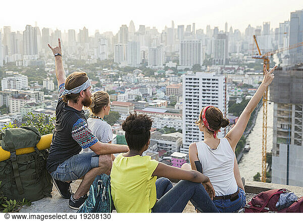 Friends looking at city view from rooftop