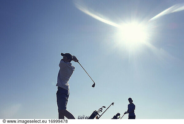 Friends playing golf clear blue sky during sunny day