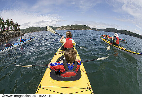 Friends sea kayaking in the San Juan Islands on June 8  2007 around Deception Island  Anacortes  Washington.