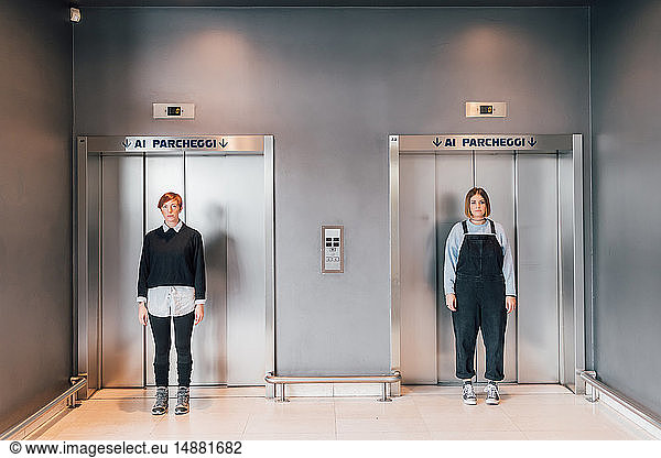 Friends standing in front of lift doors