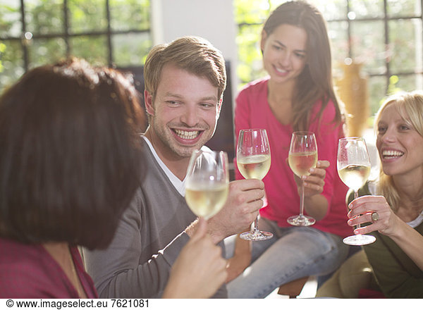 Friends toasting each other with wine