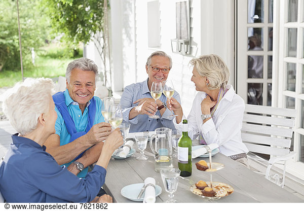 Friends toasting each other with wine outdoors