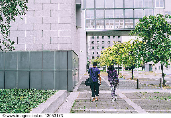 Friends walking in building complex  Milan  Italy