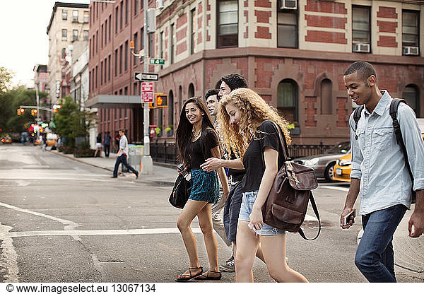 Friends walking on city street