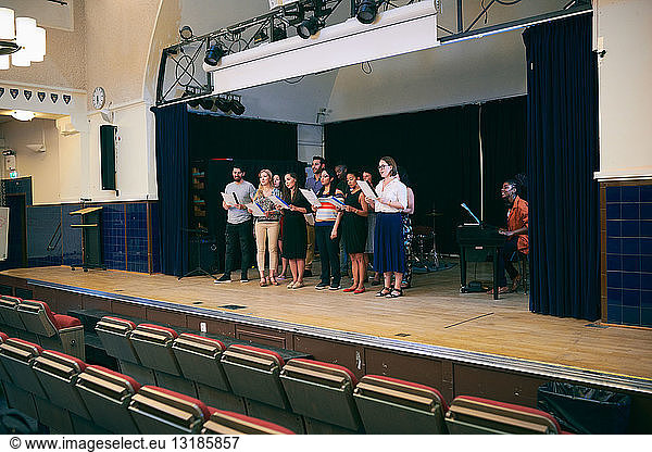 Friends with music sheets singing at choir practice