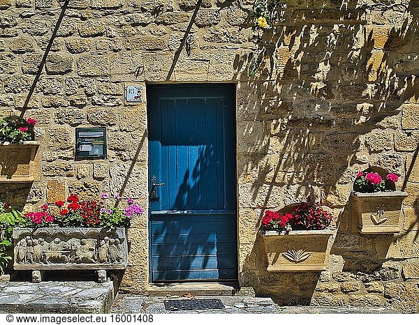Front of house with blue door and flowers  Domme  Dordogne Department  Nouvelle Aquitaine  France.