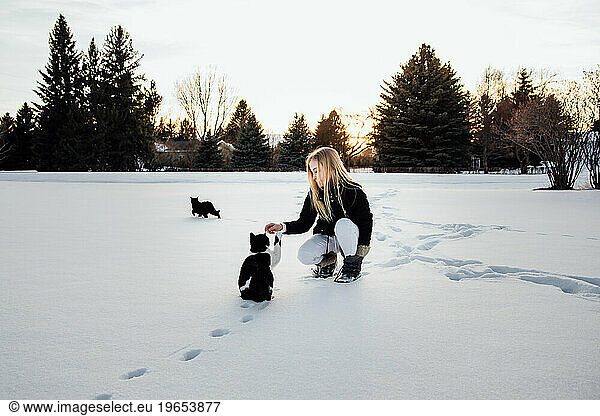 Front view of teen girl with long blonde hair and winter gear kn