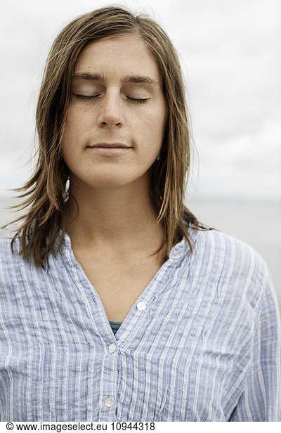 Front view of woman relaxing with eyes closed