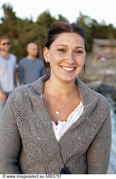 Front view of young woman with friends in background